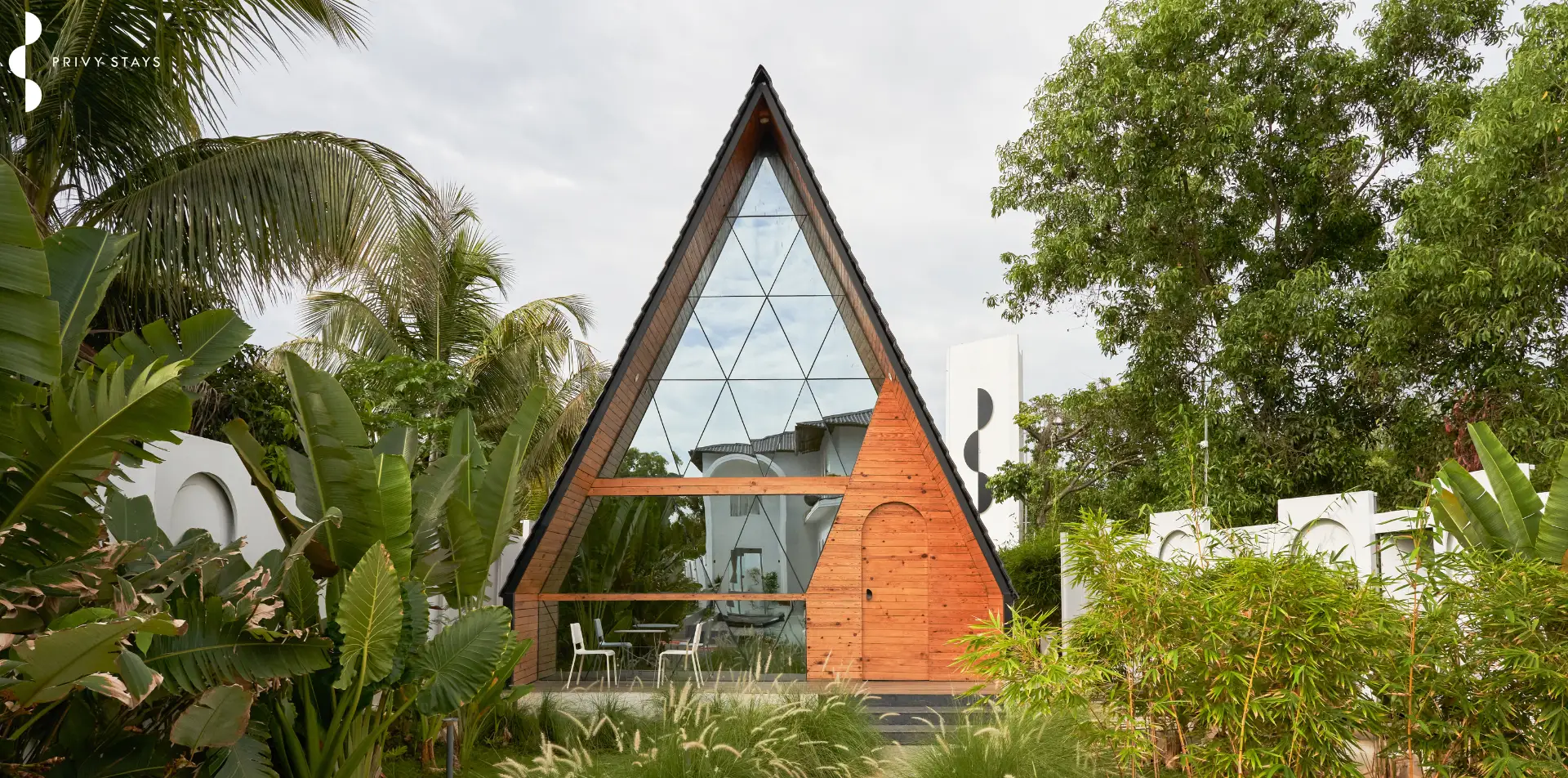 A modern Privy Stays villa nestled in lush nature with mountains at sunrise